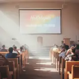 Bright projector light filling a wood-pew church sanctuary with colorful worship slides on screen